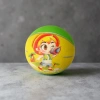 A green basketball with a purple cartoon dinosaur pattern printed on its surface, wearing a yellow headscarf with red dots, an orange outfit, and decorated with a small orange basketball and blue-green leaves Specification image